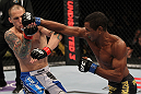 FAIRFAX, VA - MAY 15:  (R-L) Johnny Eduardo punches Jeff Curran in a bantamweight bout during the UFC on Fuel TV event at Patriot Center on May 15, 2012 in Fairfax, Virginia.  (Photo by Josh Hedges/Zuffa LLC/Zuffa LLC via Getty Images)