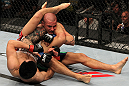 FAIRFAX, VA - MAY 15:  (L-R) "The Korean Zombie" Chan Sung Jung attempts to secure a triangle choke submission against Dustin Poirier in a featherweight bout during the UFC on Fuel TV event at Patriot Center on May 15, 2012 in Fairfax, Virginia.  (Photo by Josh Hedges/Zuffa LLC/Zuffa LLC via Getty Images)