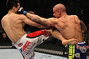 FAIRFAX, VA - MAY 15:  (L-R) "The Korean Zombie" Chan Sung Jung and Dustin Poirier trade strikes in a featherweight bout during the UFC on Fuel TV event at Patriot Center on May 15, 2012 in Fairfax, Virginia.  (Photo by Josh Hedges/Zuffa LLC/Zuffa LLC via Getty Images)