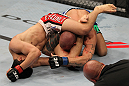 FAIRFAX, VA - MAY 15:  (L-R) "The Korean Zombie" Chan Sung Jung attempts to secure a triangle choke submission against Dustin Poirier in a featherweight bout during the UFC on Fuel TV event at Patriot Center on May 15, 2012 in Fairfax, Virginia.  (Photo by Josh Hedges/Zuffa LLC/Zuffa LLC via Getty Images)