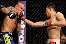 FAIRFAX, VA - MAY 15:  (R-L) "The Korean Zombie" Chan Sung Jung punches Dustin Poirier in a featherweight bout during the UFC on Fuel TV event at Patriot Center on May 15, 2012 in Fairfax, Virginia.  (Photo by Josh Hedges/Zuffa LLC/Zuffa LLC via Getty Images)