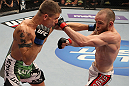 FAIRFAX, VA - MAY 15:  (L-R) Carlo Prater and TJ Grant trade punches in a lightweight bout during the UFC on Fuel TV event at Patriot Center on May 15, 2012 in Fairfax, Virginia.  (Photo by Josh Hedges/Zuffa LLC/Zuffa LLC via Getty Images)