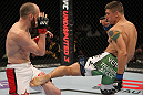 FAIRFAX, VA - MAY 15:  (R-L) TJ Grant punches Carlo Prater in a lightweight bout during the UFC on Fuel TV event at Patriot Center on May 15, 2012 in Fairfax, Virginia.  (Photo by Josh Hedges/Zuffa LLC/Zuffa LLC via Getty Images)