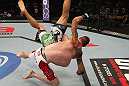 FAIRFAX, VA - MAY 15:  TJ Grant (white/red shorts) slams Carlo Prater in a lightweight bout during the UFC on Fuel TV event at Patriot Center on May 15, 2012 in Fairfax, Virginia.  (Photo by Josh Hedges/Zuffa LLC/Zuffa LLC via Getty Images)