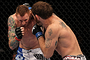 FAIRFAX, VA - MAY 15:  (R-L) Tom Lawlor punches Jason MacDonald in a middleweight bout during the UFC on Fuel TV event at Patriot Center on May 15, 2012 in Fairfax, Virginia.  (Photo by Josh Hedges/Zuffa LLC/Zuffa LLC via Getty Images)