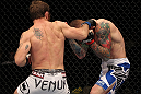 FAIRFAX, VA - MAY 15:  (L-R) Tom Lawlor punches Jason MacDonald in a middleweight bout during the UFC on Fuel TV event at Patriot Center on May 15, 2012 in Fairfax, Virginia.  (Photo by Josh Hedges/Zuffa LLC/Zuffa LLC via Getty Images)