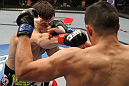 FAIRFAX, VA - MAY 15:  (L-R) Amir Sadollah punches Jorge Lopez in a welterweight bout during the UFC on Fuel TV event at Patriot Center on May 15, 2012 in Fairfax, Virginia.  (Photo by Josh Hedges/Zuffa LLC/Zuffa LLC via Getty Images)