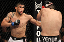 FAIRFAX, VA - MAY 15:  (L-R) Jorge Lopez punches Amir Sadollah in a welterweight bout during the UFC on Fuel TV event at Patriot Center on May 15, 2012 in Fairfax, Virginia.  (Photo by Josh Hedges/Zuffa LLC/Zuffa LLC via Getty Images)