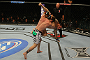 LAS VEGAS, NV - MAY 26:  Mike Brown (white shorts) slams Daniel Pineda during a light featherweight bout at UFC 146 at MGM Grand Garden Arena on May 26, 2012 in Las Vegas, Nevada.  (Photo by Donald Miralle/Zuffa LLC/Zuffa LLC via Getty Images)