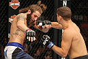 LAS VEGAS, NV - JUNE 01:   (R-L) Al Iaquinta punches Michael Chiesa in a Lightweight bout during The Ultimate Fighter Live Finale at the Pearl Theater at the Palms Casino Resort on June 1, 2012 in Las Vegas, Nevada.  (Photo by Josh Hedges/Zuffa LLC/Zuffa LLC via Getty Images)  *** Local Caption *** Al Iaquinta; Michael Chiesa