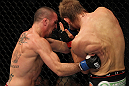SUNRISE, FL - JUNE 08:   (L-R) Josh Neer punches Mike Pyle in a Welterweight bout during the UFC on FX 3 event at Bank Atlantic Center on June 8, 2012 in Sunrise, Florida.  (Photo by Josh Hedges/Zuffa LLC/Zuffa LLC via Getty Images)