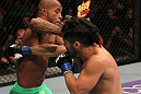 SUNRISE, FL - JUNE 08:   (L-R) Demetrious Johnson punches Ian McCall in a Flyweight bout during the UFC on FX 3 event at Bank Atlantic Center on June 8, 2012 in Sunrise, Florida.  (Photo by Josh Hedges/Zuffa LLC/Zuffa LLC via Getty Images)