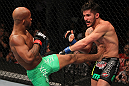 SUNRISE, FL - JUNE 08:   (L-R) Demetrious Johnson kicks Ian McCall in a Flyweight bout during the UFC on FX 3 event at Bank Atlantic Center on June 8, 2012 in Sunrise, Florida.  (Photo by Josh Hedges/Zuffa LLC/Zuffa LLC via Getty Images)