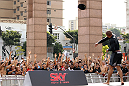 BELO HORIZONTE, BRAZIL - JUNE 20:   Sergio Moraes tosses a t-shirt in the crowd during the UFC 147 open workouts at Praca da Estacao on June 20, 2012 in Belo Horizonte, Brazil.  (Photo by Josh Hedges/Zuffa LLC/Zuffa LLC via Getty Images)