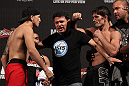 BELO HORIZONTE, BRAZIL - JUNE 22:   (L-R) Opponents Anistavio Medeiros and Rodrigo Damm are separated after facing off during the UFC 147 weigh in at Estadio Jornalista Felipe Drummond on June 22, 2012 in Belo Horizonte, Brazil.  (Photo by Josh Hedges/Zuffa LLC/Zuffa LLC via Getty Images)