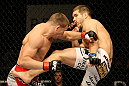 ATLANTIC CITY, NJ - JUNE 22:  Brock Jardine (R) kicks Rick Story (L) who hits him with a punch in a welterweight bout during UFC on FX 4 at Revel Casino on June 22, 2012 in Atlantic City, New Jersey.  (Photo by Nick Laham/Zuffa LLC/Zuffa LLC)