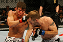 ATLANTIC CITY, NJ - JUNE 22:  Sam Stout (L) punches Spencer Fisher (R) in a lightweight bout during UFC on FX 4 at Revel Casino on June 22, 2012 in Atlantic City, New Jersey.  (Photo by Nick Laham/Zuffa LLC/Zuffa LLC)