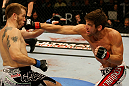 ATLANTIC CITY, NJ - JUNE 22: Sam Stout (R) punches Spencer Fisher (L) in a lightweight bout during UFC on FX 4 at Revel Casino on June 22, 2012 in Atlantic City, New Jersey.  (Photo by Nick Laham/Zuffa LLC/Zuffa LLC)