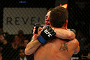 ATLANTIC CITY, NJ - JUNE 22:  (L-R) Spencer Fisher and Sam Stout show camaraderie after their lightweight bout during UFC on FX 4 at Revel Casino on June 22, 2012 in Atlantic City, New Jersey.  Stout won by unanimous decision. (Photo by Nick Laham/Zuffa LLC/Zuffa LLC)