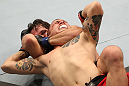 BELO HORIZONTE, BRAZIL - JUNE 23:   (L-R) Rodrigo Damm secures a rear choke submission to defeat Anistavio "Gasparzinho" Medeiros during their UFC 147 featherweight bout at Estadio Jornalista Felipe Drummond on June 23, 2012 in Belo Horizonte, Brazil.  (Photo by Josh Hedges/Zuffa LLC/Zuffa LLC via Getty Images)