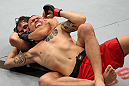 BELO HORIZONTE, BRAZIL - JUNE 23:   (L-R) Rodrigo Damm secures a rear choke submission to defeat Anistavio "Gasparzinho" Medeiros during their UFC 147 featherweight bout at Estadio Jornalista Felipe Drummond on June 23, 2012 in Belo Horizonte, Brazil.  (Photo by Josh Hedges/Zuffa LLC/Zuffa LLC via Getty Images)