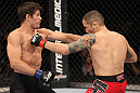 BELO HORIZONTE, BRAZIL - JUNE 23:   (L-R) Rodrigo Damm lands a left that drops Anistavio "Gasparzinho" Medeiros during their UFC 147 featherweight bout at Estadio Jornalista Felipe Drummond on June 23, 2012 in Belo Horizonte, Brazil.  (Photo by Josh Hedges/Zuffa LLC/Zuffa LLC via Getty Images)