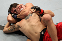 BELO HORIZONTE, BRAZIL - JUNE 23:   (L-R) Rodrigo Damm secures a rear choke submission to defeat Anistavio "Gasparzinho" Medeiros during their UFC 147 featherweight bout at Estadio Jornalista Felipe Drummond on June 23, 2012 in Belo Horizonte, Brazil.  (Photo by Josh Hedges/Zuffa LLC/Zuffa LLC via Getty Images)