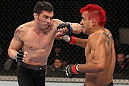 BELO HORIZONTE, BRAZIL - JUNE 23:   (L-R) Rony "Jason" Mariano Bezerra punches Godofredo Pepey during their UFC 147 featherweight bout at Estadio Jornalista Felipe Drummond on June 23, 2012 in Belo Horizonte, Brazil.  (Photo by Josh Hedges/Zuffa LLC/Zuffa LLC via Getty Images)