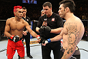 BELO HORIZONTE, BRAZIL - JUNE 23:   (L-R) Opponents Godofredo Pepey and Rony "Jason" Mariano Bezerra receive final instructions from the referee before their UFC 147 featherweight bout at Estadio Jornalista Felipe Drummond on June 23, 2012 in Belo Horizonte, Brazil.  (Photo by Josh Hedges/Zuffa LLC/Zuffa LLC via Getty Images)