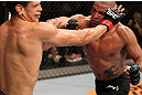 BELO HORIZONTE, BRAZIL - JUNE 23:   (R-L) Sergio "Serginho" Moraes punches Cezar "Mutante" Ferreira during their UFC 147 middleweight bout at Estadio Jornalista Felipe Drummond on June 23, 2012 in Belo Horizonte, Brazil.  (Photo by Josh Hedges/Zuffa LLC/Zuffa LLC via Getty Images)