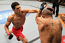 BELO HORIZONTE, BRAZIL - JUNE 23:   (L-R) Cezar "Mutante" Ferreira punches Sergio "Serginho" Moraes during their UFC 147 middleweight bout at Estadio Jornalista Felipe Drummond on June 23, 2012 in Belo Horizonte, Brazil.  (Photo by Josh Hedges/Zuffa LLC/Zuffa LLC via Getty Images)