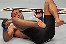 BELO HORIZONTE, BRAZIL - JUNE 23:   Sergio "Serginho" Moraes lies on the canvas after being knocked down by Cezar "Mutante" Ferreira during their UFC 147 middleweight bout at Estadio Jornalista Felipe Drummond on June 23, 2012 in Belo Horizonte, Brazil.  (Photo by Josh Hedges/Zuffa LLC/Zuffa LLC via Getty Images)