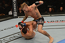 LAS VEGAS, NV - JULY 7:   John Alessio (top) punches Shane Roller during their lightweight bout at UFC 148 inside MGM Grand Garden Arena on July 7, 2012 in Las Vegas, Nevada.  (Photo by Donald Miralle/Zuffa LLC/Zuffa LLC via Getty Images)  *** Local Caption *** John Alessio; Shane Roller