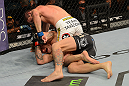 LAS VEGAS, NV - JULY 7:   Shane Roller (top) punches John Alessio during their lightweight bout at UFC 148 inside MGM Grand Garden Arena on July 7, 2012 in Las Vegas, Nevada.  (Photo by Donald Miralle/Zuffa LLC/Zuffa LLC via Getty Images)  *** Local Caption *** John Alessio; Shane Roller