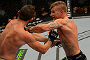 LAS VEGAS, NV - JULY 7:   (R-L) John Alessio punches Shane Roller during their lightweight bout at UFC 148 inside MGM Grand Garden Arena on July 7, 2012 in Las Vegas, Nevada.  (Photo by Donald Miralle/Zuffa LLC/Zuffa LLC via Getty Images)  *** Local Caption *** John Alessio; Shane Roller