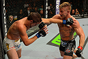 LAS VEGAS, NV - JULY 7:   (R-L) John Alessio punches Shane Roller during their lightweight bout at UFC 148 inside MGM Grand Garden Arena on July 7, 2012 in Las Vegas, Nevada.  (Photo by Donald Miralle/Zuffa LLC/Zuffa LLC via Getty Images)  *** Local Caption *** John Alessio; Shane Roller