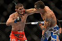 LAS VEGAS, NV - JULY 7:   (R-L) Gleison Tibau punches Khabib Nurmagomedov during their lightweight bout at UFC 148 inside MGM Grand Garden Arena on July 7, 2012 in Las Vegas, Nevada.  (Photo by Donald Miralle/Zuffa LLC/Zuffa LLC via Getty Images)  *** Local Caption *** Khabib Nurmagomedov; Gleison Tibau