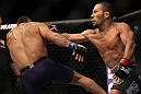 LAS VEGAS, NV - JULY 7:   (R-L) Ivan Menjivar punches Mike Easton during their bantamweight bout at UFC 148 inside MGM Grand Garden Arena on July 7, 2012 in Las Vegas, Nevada.  (Photo by Josh Hedges/Zuffa LLC/Zuffa LLC via Getty Images)  *** Local Caption *** Ivan Menjivar; Mike Easton