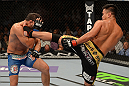 LAS VEGAS, NV - JULY 7:   Cung Le (right) kicks Patrick Cote during their middleweight bout at UFC 148 inside MGM Grand Garden Arena on July 7, 2012 in Las Vegas, Nevada.  (Photo by Donald Miralle/Zuffa LLC/Zuffa LLC via Getty Images)  *** Local Caption *** Cung Le; Patrick Cote