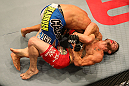 SAN JOSE, CA - JULY 11:   Josh Ferguson (red shorts) attempts to submit Chris Cariaso during their flyweight bout at HP Pavilion on July 11, 2012 in San Jose, California.  (Photo by Ezra Shaw/Zuffa LLC/Zuffa LLC via Getty Images)  *** Local Caption *** Chris Cariaso; Josh Ferguson