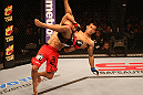 SAN JOSE, CA - JULY 11:   TJ Dillashaw (red shorts) lifts Vaughan Lee into the air during their bantamweight bout at HP Pavilion on July 11, 2012 in San Jose, California.  (Photo by Ezra Shaw/Zuffa LLC/Zuffa LLC via Getty Images)  *** Local Caption *** T.J. Dillashaw; Vaughn Lee