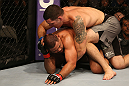 SAN JOSE, CA - JULY 11:   Chris Weidman (grey shorts) punches Mark Munoz during their middleweight bout at HP Pavilion on July 11, 2012 in San Jose, California.  (Photo by Ezra Shaw/Zuffa LLC/Zuffa LLC via Getty Images)  *** Local Caption *** Mark Munoz; Chris Weidman