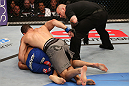 SAN JOSE, CA - JULY 11:   Chris Weidman (grey shorts) punches Mark Munoz (blue shorts) as referee Josh Rosenthal during their middleweight bout at HP Pavilion on July 11, 2012 in San Jose, California.  (Photo by Ezra Shaw/Zuffa LLC/Zuffa LLC via Getty Images)  *** Local Caption *** Mark Munoz; Chris Weidman; Josh Rosenthal