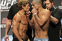 CALGARY, CANADA - JULY 20:  Urijah Faber and Renan Barao square off at the UFC 149 weigh-in at the Scotiabank Saddledome on July 20, 2012 in Calgary, Alberta, Canada.  (Photo by Jeff Bottari/Zuffa LLC/Zuffa LLC via Getty Images)
