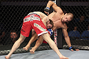 CALGARY, CANADA - JULY 21:  Mitch Clarke takes down Anton Kuivanen during their lightweight bout at UFC 149 inside the Scotiabank Saddledome on July 21, 2012 in Calgary, Alberta, Canada.  (Photo by Nick Laham/Zuffa LLC/Zuffa LLC via Getty Images)