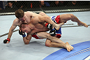 CALGARY, CANADA - JULY 21: (L-R) Mitch Clarke grapples Anton Kuivanen during their lightweight bout at UFC 149 inside the Scotiabank Saddledome on July 21, 2012 in Calgary, Alberta, Canada.  (Photo by Nick Laham/Zuffa LLC/Zuffa LLC via Getty Images)