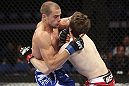 CALGARY, CANADA - JULY 21: (L-R) Anton Kuivanen attacks Mitch Clarke during their lightweight bout at UFC 149 inside the Scotiabank Saddledome on July 21, 2012 in Calgary, Alberta, Canada.  (Photo by Nick Laham/Zuffa LLC/Zuffa LLC via Getty Images)