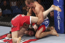 CALGARY, CANADA - JULY 21: (L-R) Mitch Clarke gets flipped by Anton Kuivanen during their lightweight bout at UFC 149 inside the Scotiabank Saddledome on July 21, 2012 in Calgary, Alberta, Canada.  (Photo by Nick Laham/Zuffa LLC/Zuffa LLC via Getty Images)