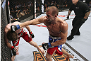 CALGARY, CANADA - JULY 21:  (R-L) Anton Kuivanen throws a punch at Mitch Clarke during their lightweight bout at UFC 149 inside the Scotiabank Saddledome on July 21, 2012 in Calgary, Alberta, Canada.  (Photo by Nick Laham/Zuffa LLC/Zuffa LLC via Getty Images)