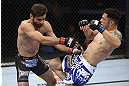CALGARY, CANADA - JULY 21: (L-R) Antonio Carvalho exchanges punches with Daniel Pineda during their featherweight bout at UFC 149 inside the Scotiabank Saddledome on July 21, 2012 in Calgary, Alberta, Canada.  (Photo by Nick Laham/Zuffa LLC/Zuffa LLC via Getty Images)